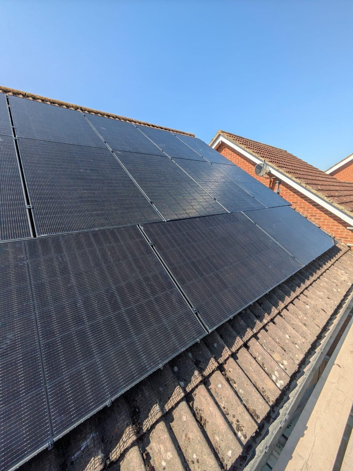 Perspective view along a large residential solar PV array in Winchester