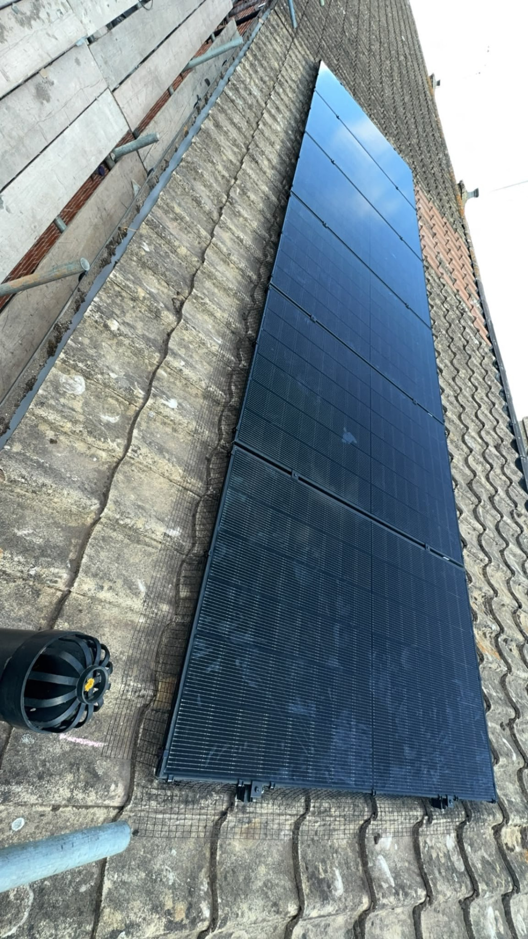 Completed run of black solar panels on a pantile roof in Winchester