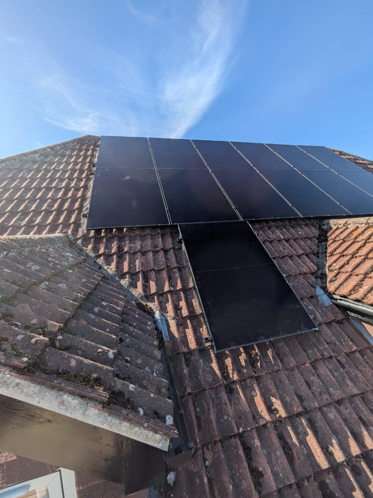 Solar panels fitted around a complex roofline on a Hampshire home