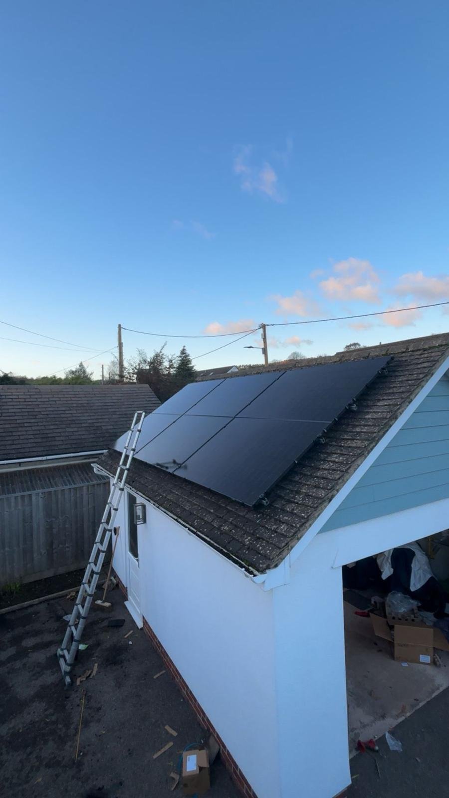 Solar panels installed on a garage roof with access ladder in Winchester