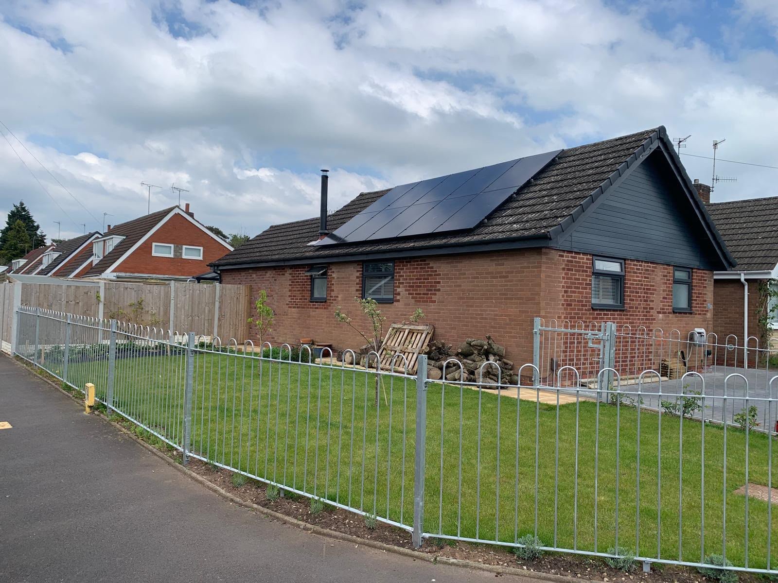 Solar panels installed on a red brick bungalow roof in Hampshire
