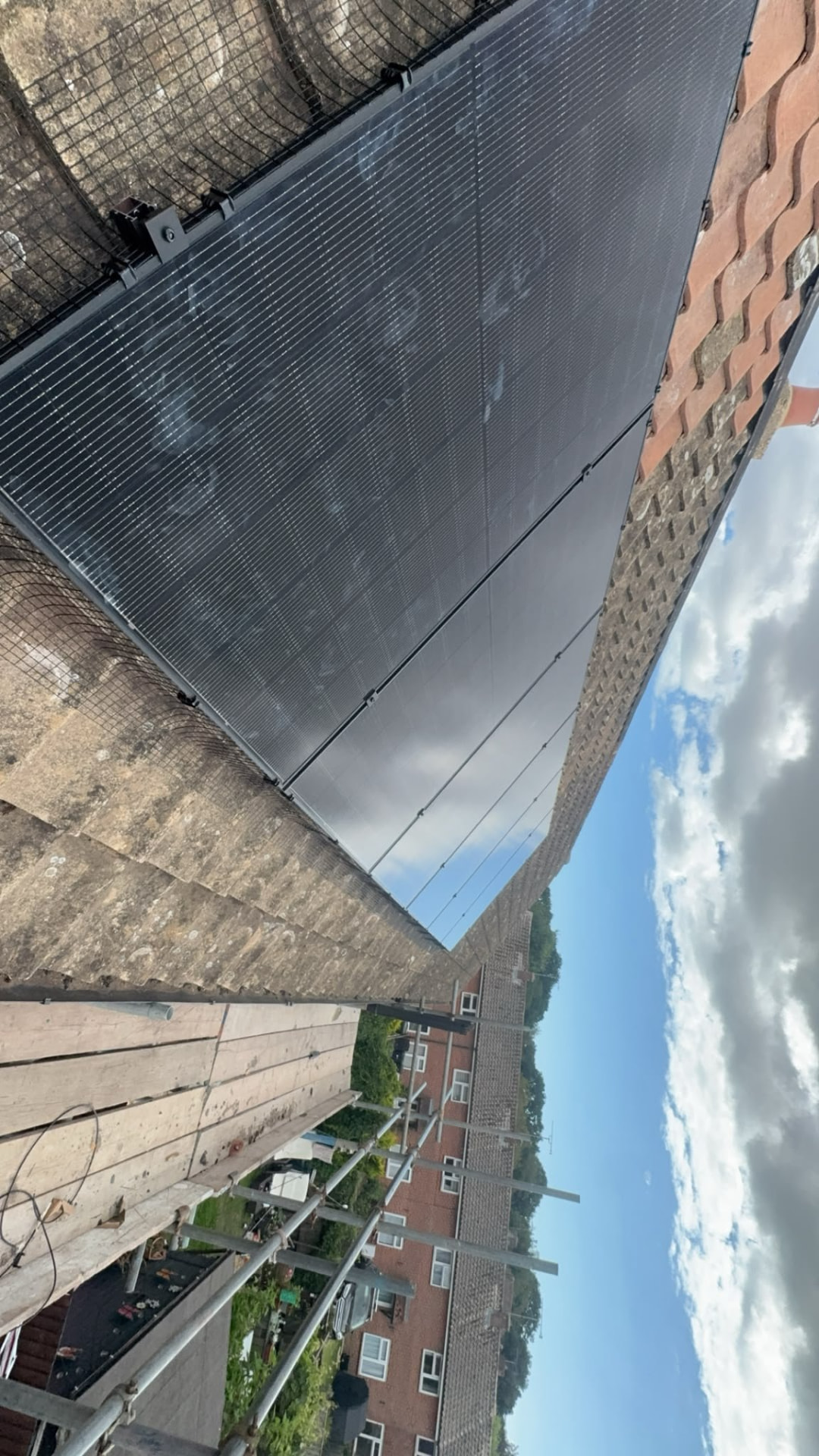 Solar PV panels installed on a tiled roof above a Hampshire terrace