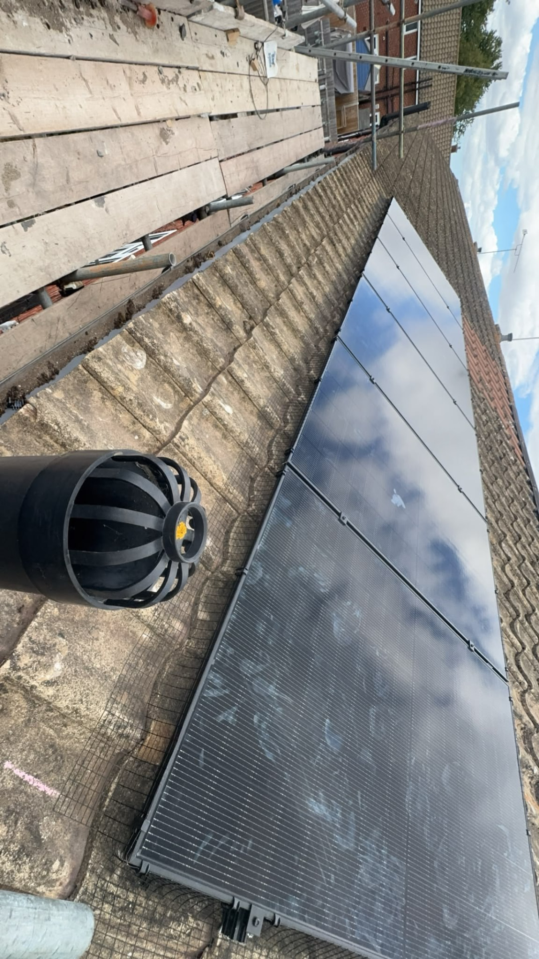 Solar panels installed beside a roof vent on a tiled Hampshire roof