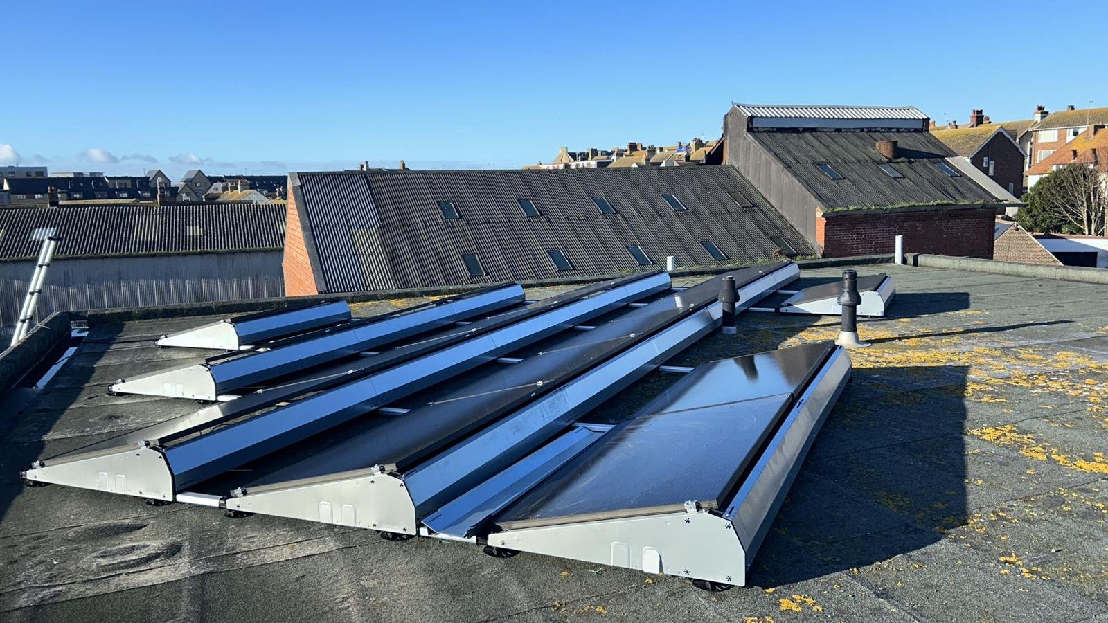 East-west flat roof solar mounting frames on a commercial rooftop