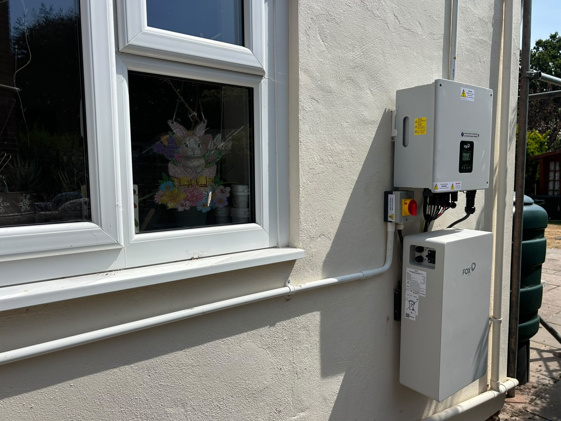 Exterior Fox ESS battery storage installation beside a uPVC window