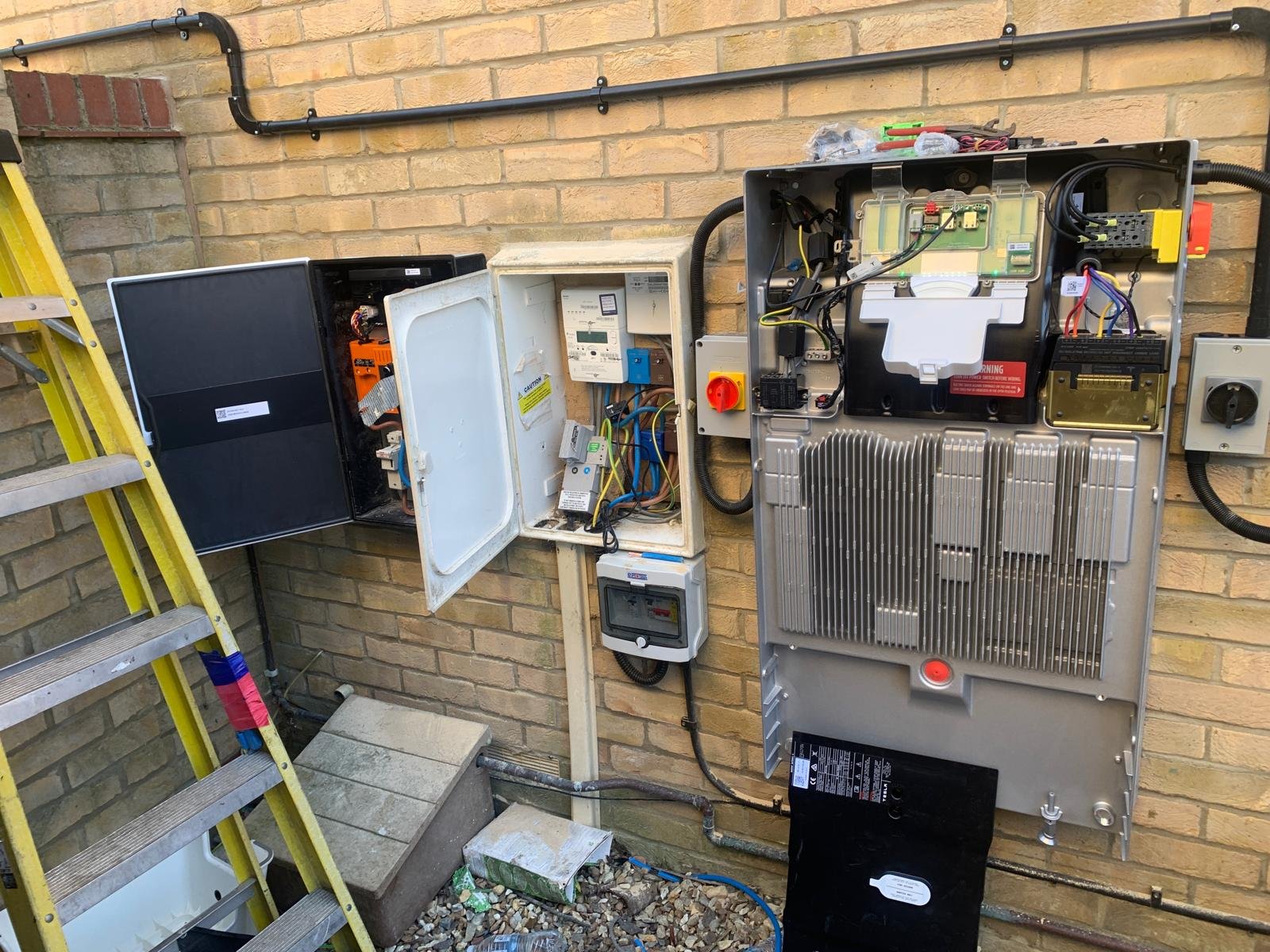 Electrical panel, isolators and inverter wiring installed on a brick wall in Winchester